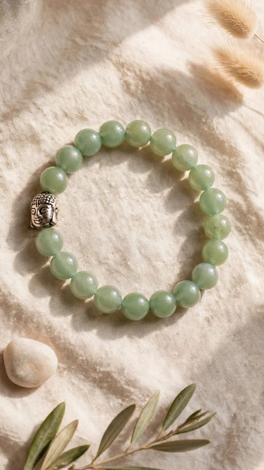 Green Aventurine Buddha bracelet on natural linen with olive leaves