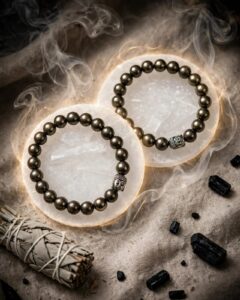 Two natural Pyrite bracelets with 8 mm beads and Buddha bead on selenite plates with sage and black tourmaline