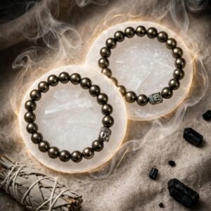 Two natural Pyrite bracelets with 8 mm beads and Buddha bead on selenite plates with sage and black tourmaline