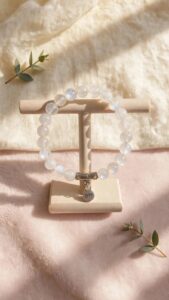 Natural Rainbow Moonstone bracelet with 8 mm blue flash beads and BFF charm on a wooden stand