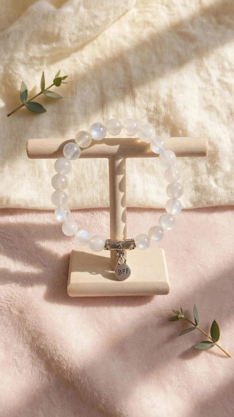 Natural Rainbow Moonstone bracelet with 8 mm blue flash beads and BFF charm on a wooden stand