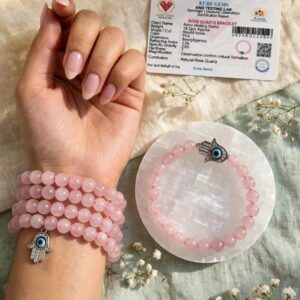 Natural Rose Quartz bracelets worn on the wrist with Hamsa charm and Kube Gems lab certificate